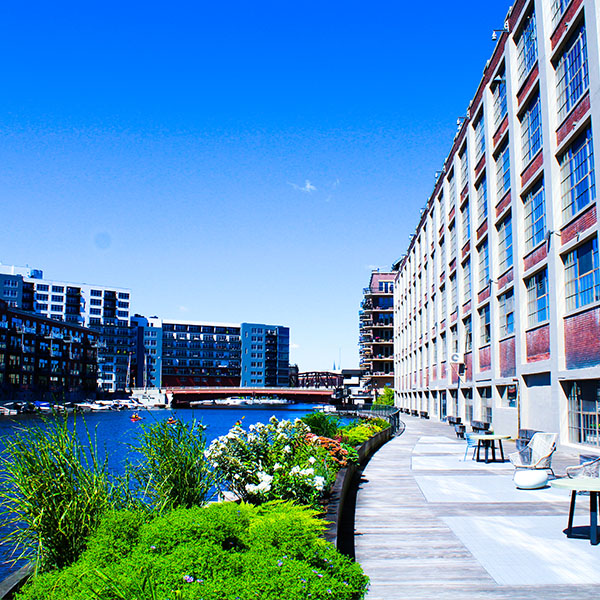 Photo of MIAD's main building and the riverwalk along the Milwaukee river